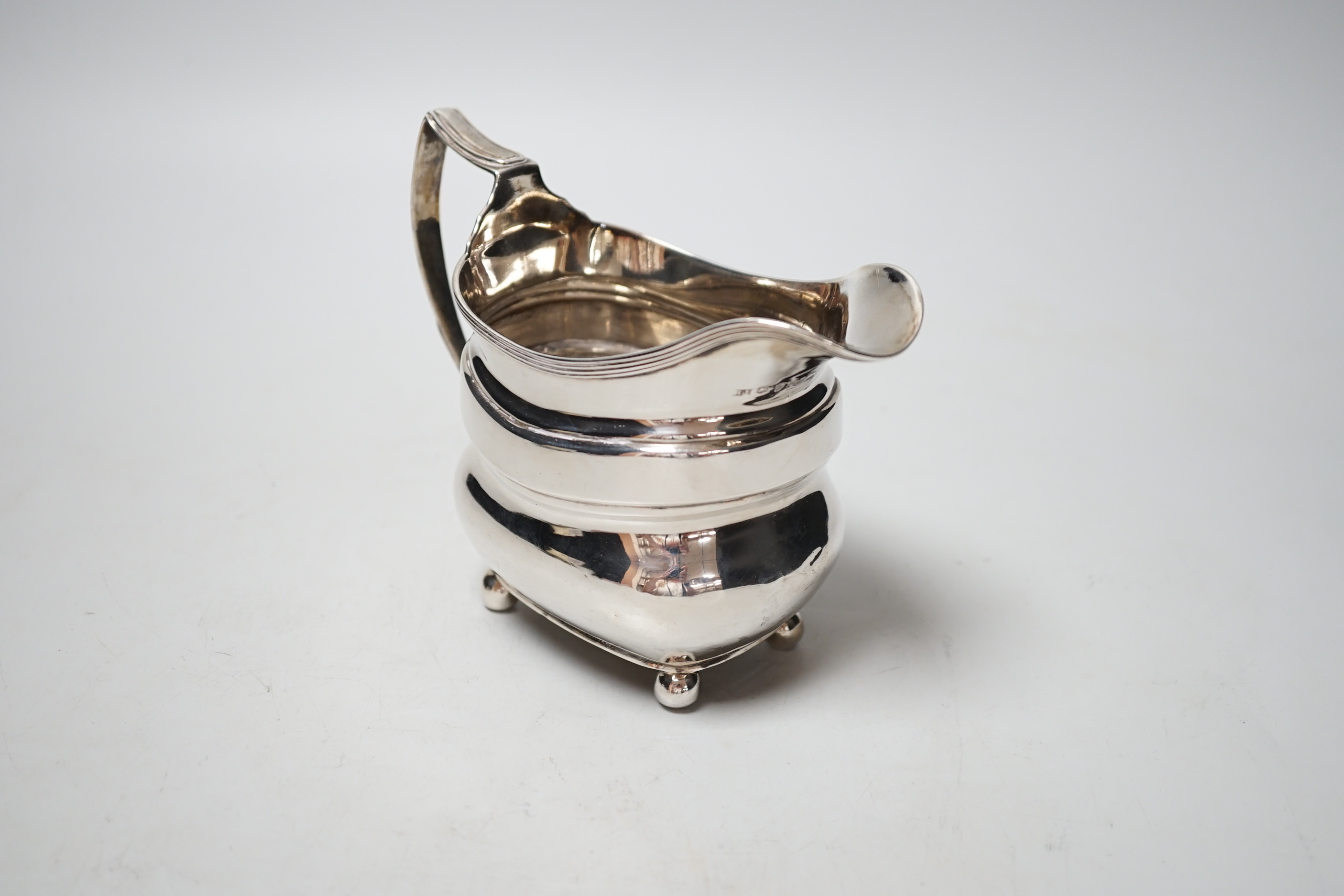 A George III silver cream jug, maker T.H?, London, 1811, 5.8oz.